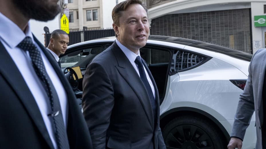 Elon Musk, chief executive officer of Tesla Inc., center, departs court in San Francisco, California, US, on Tuesday, Jan. 24, 2023. Investors suing Tesla and Musk argue that his August 2018 tweets about taking Tesla private with funding secured were indisputably false and cost them billions of dollars by spurring wild swings in Tesla's stock price. Photographer: Marlena Sloss/Bloomberg via Getty Images