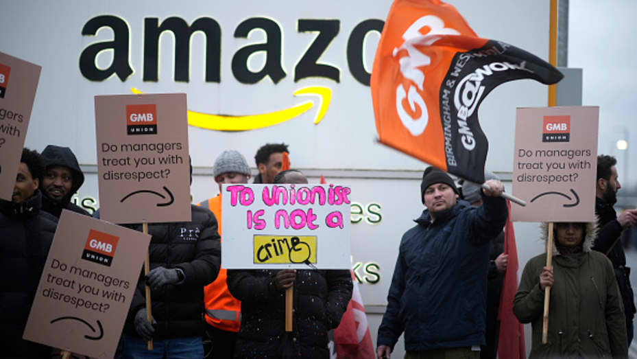Amazon workers hold GMB union placards on the picket line as they hold a strike outside the Amazon fulfillment centre on January 25, 2023 in Coventry, England.