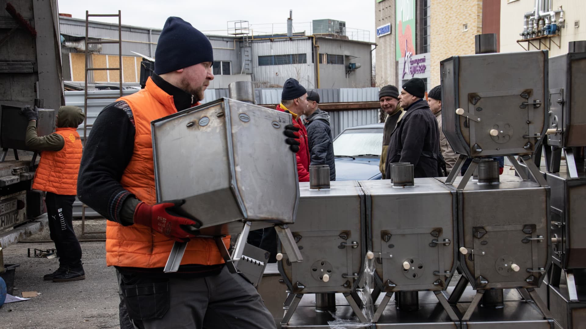 Volunteers carry stoves that were brought to the humanitarian aid center to be distributed to civilians in need and prepared by Finnish metallurgists by collecting aid in Kharkiv, Ukraine on January 25, 2023. 