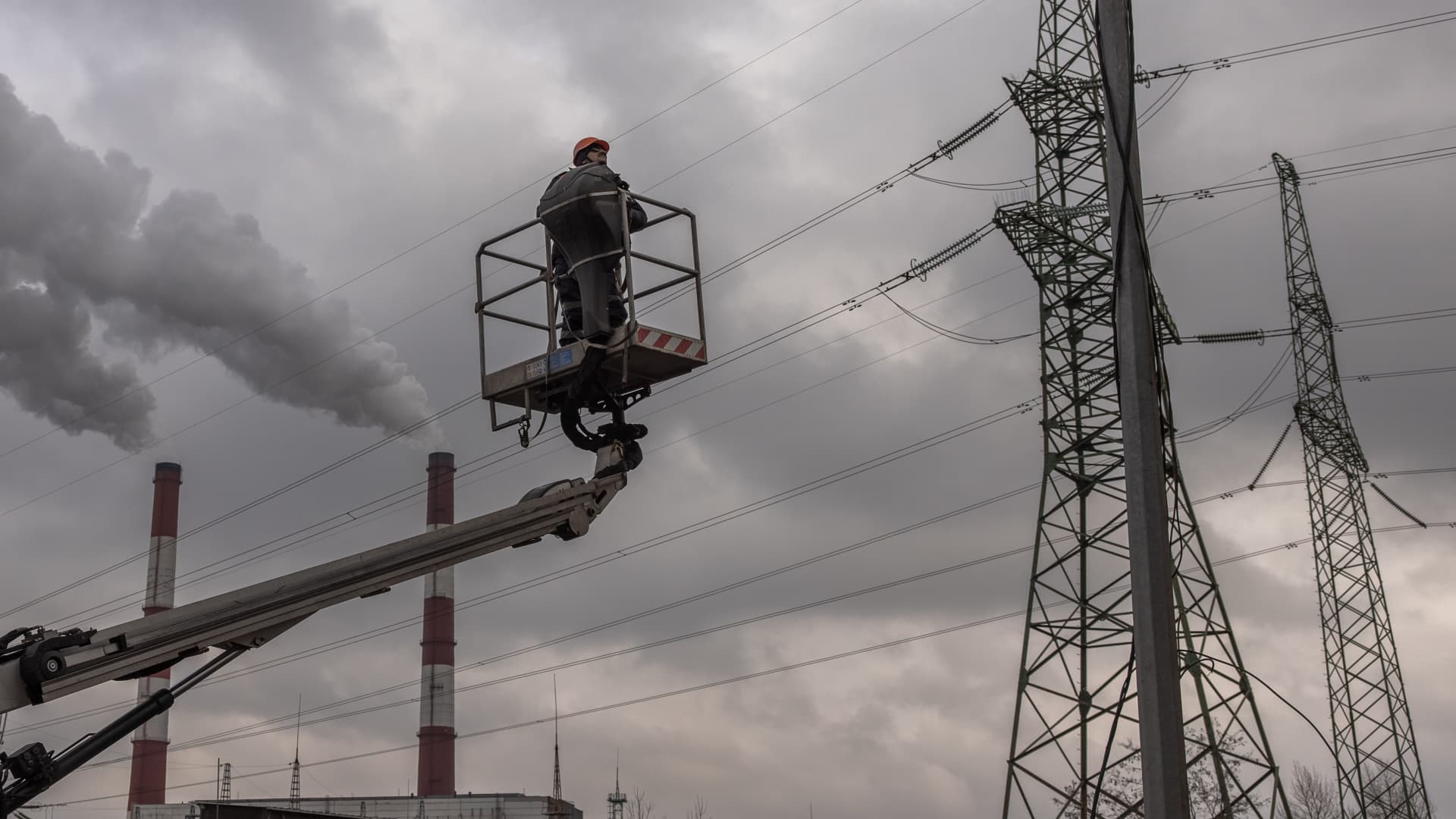 A worker is being lifted to repair electricity cables at an industrial area following a morning Russian missile strike that left one person dead and two wounded on January 26, 2023 in Kyiv, Ukraine.
