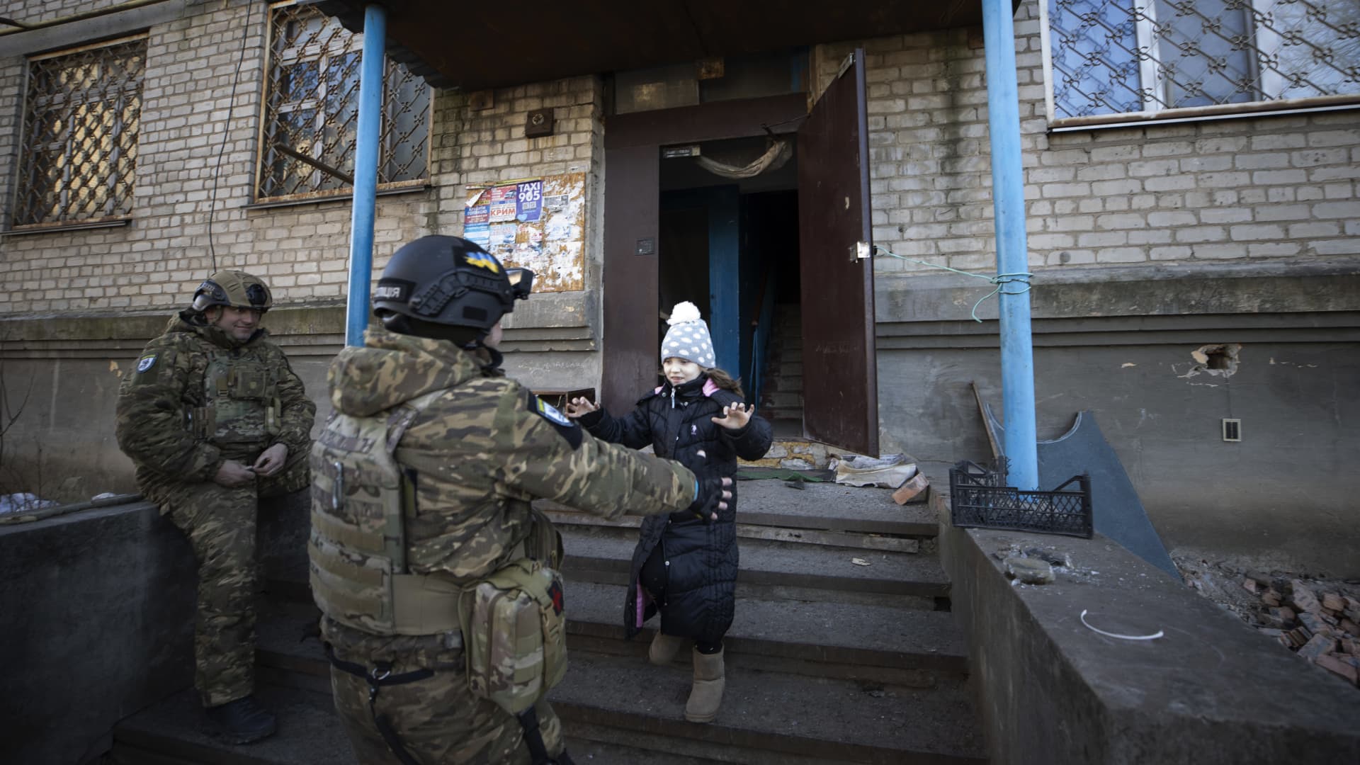 Anya, 7, plays with Ukrainian soldiers as she lives in a shelter with her family amid the war in Donetsk Oblast, Ukraine on January 25, 2023. 