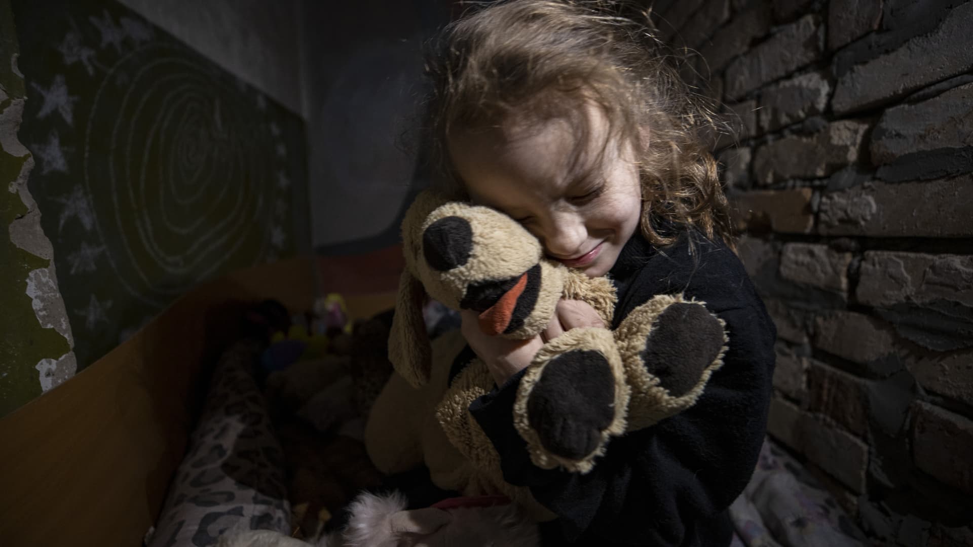 Anya, 7, plays with her toys and paints pictures to spend time in the shelter where she lives with her family amid the war in Donetsk Oblast, Ukraine on January 25, 2023. 