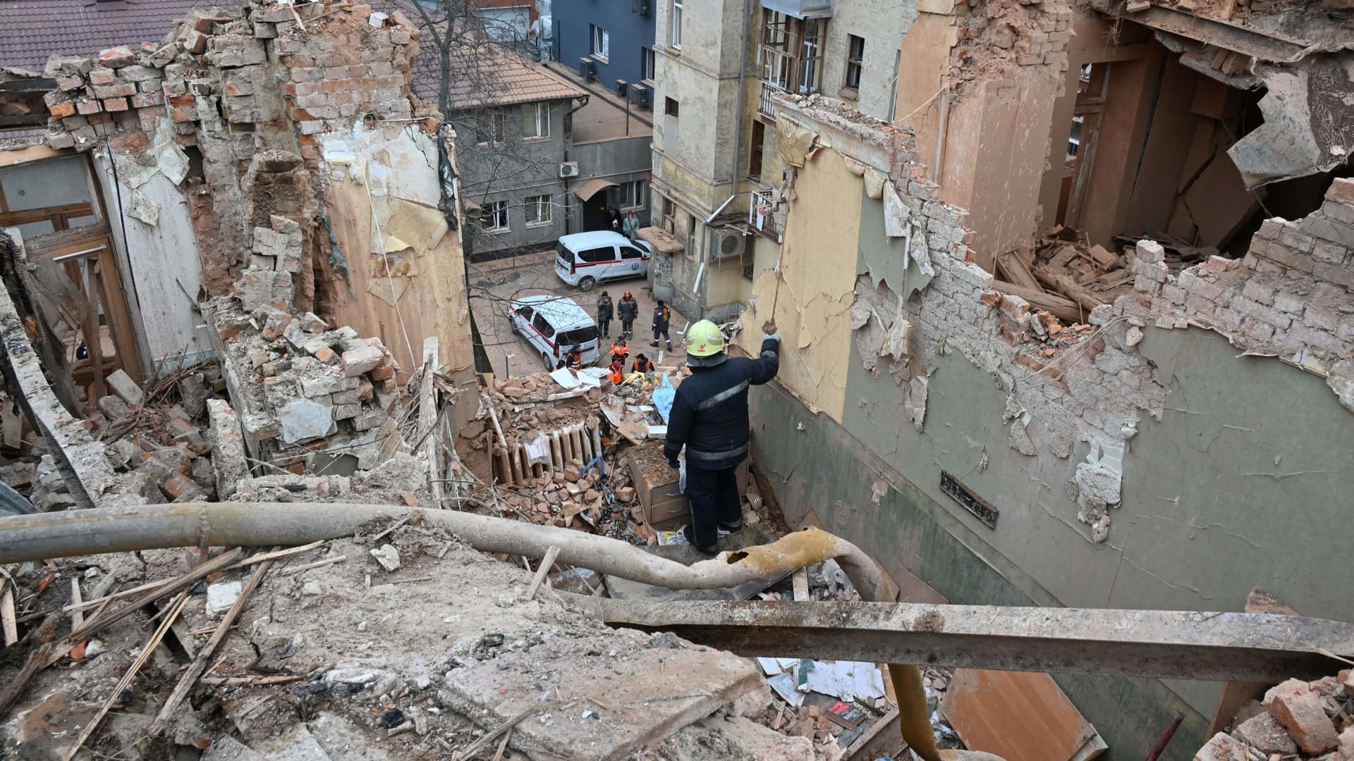 Ukrainian rescuers clear the debris of a residential building, partially destroyed after a missile strike on Kharkiv on January 30, 2023, amid the Russian invasion of Ukraine. 