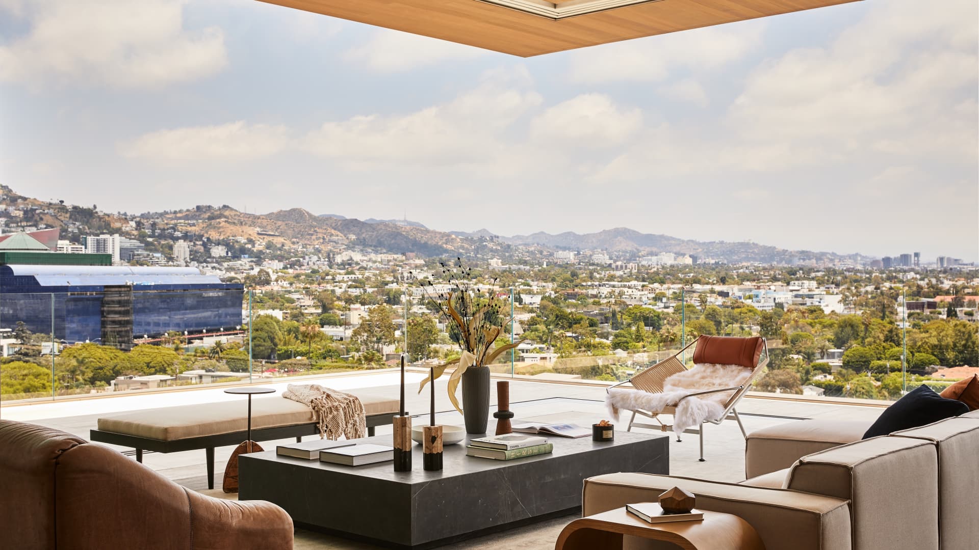 The view from 8899 Beverly Blvd's unit PHE where glass panels walls slide away and open to a wraparound balcony.