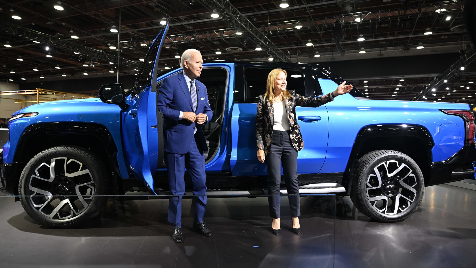President Joe Biden, with General Motors CEO Mary Barra, looks at a Chevrolet Silverado electric vehicle as he tours the 2022 North American International Auto Show at Huntington Place Convention Center in Detroit, Michigan, on Sept. 14, 2022. Biden is visiting the auto show to highlight electric vehicle manufacturing.