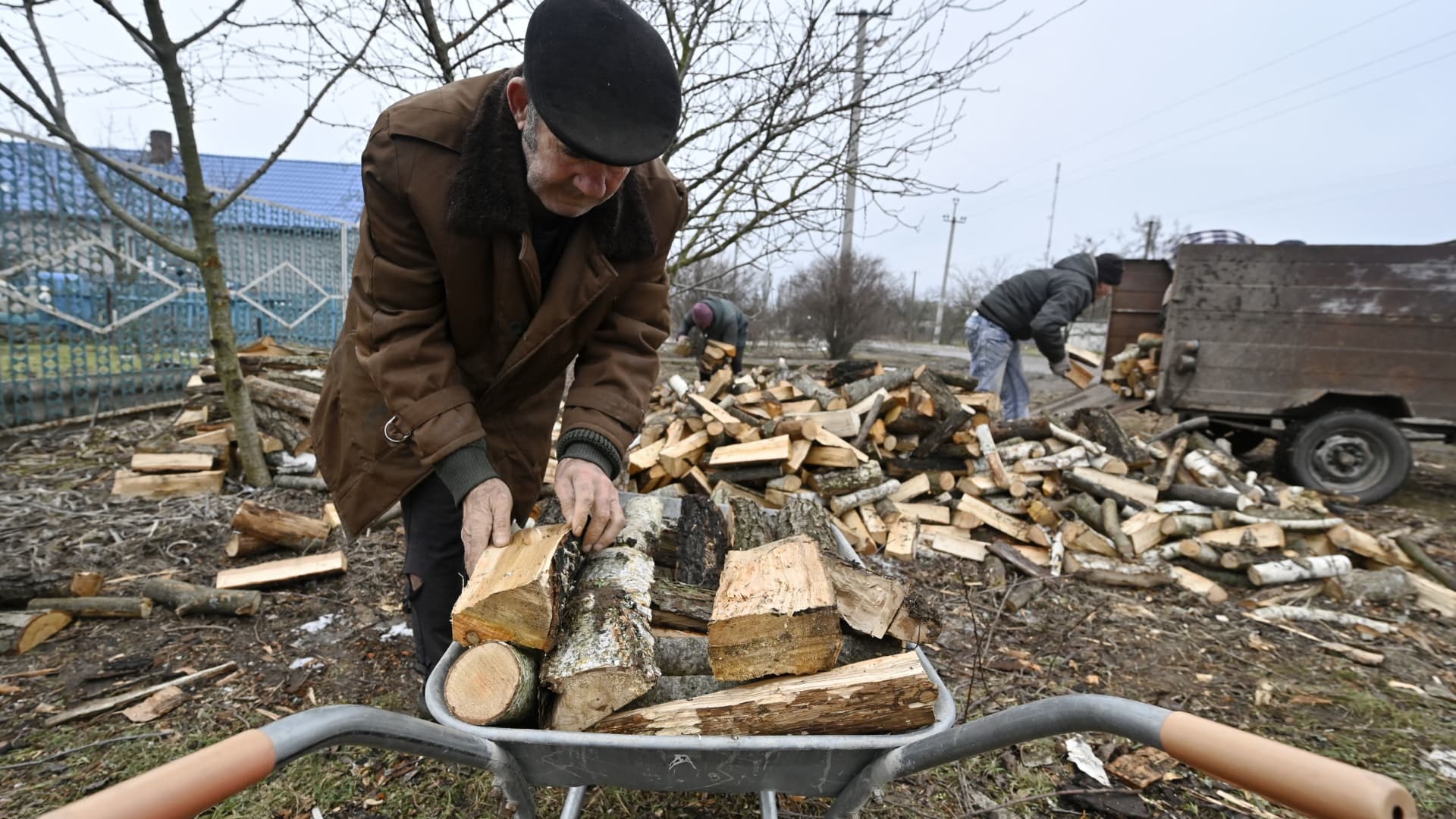 Local residents pick up firewood donated by a charity fund in Stanislav, Kherson Region, on January 31, 2023, amid the Russian invasion of Ukraine. 