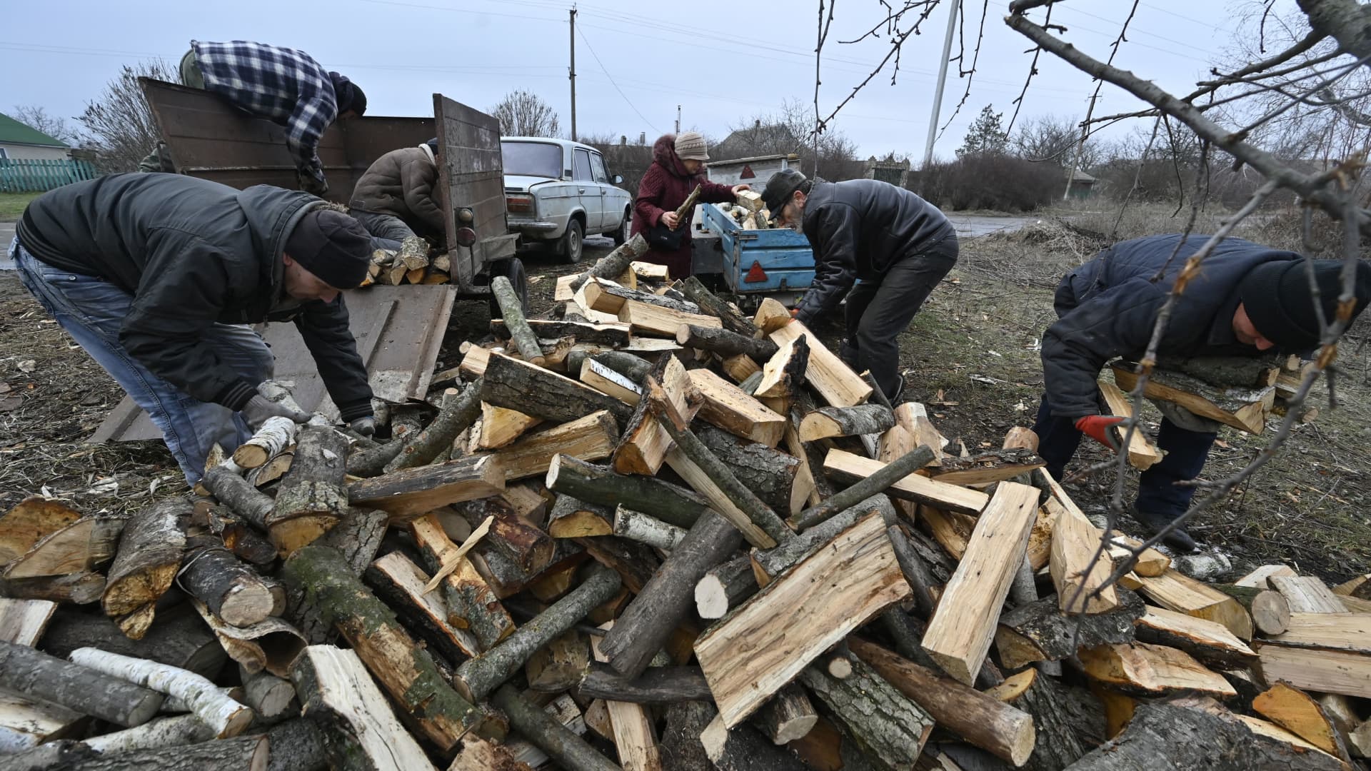 Local residents pick up firewood donated by a charity fund in Stanislav, Kherson Region, on January 31, 2023, amid the Russian invasion of Ukraine.