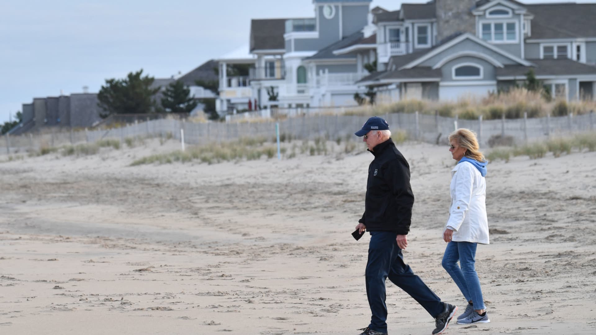 US President Joe Biden and First Lady Jill Biden walk on Rehoboth Beach, Delaware on November 7, 2021.