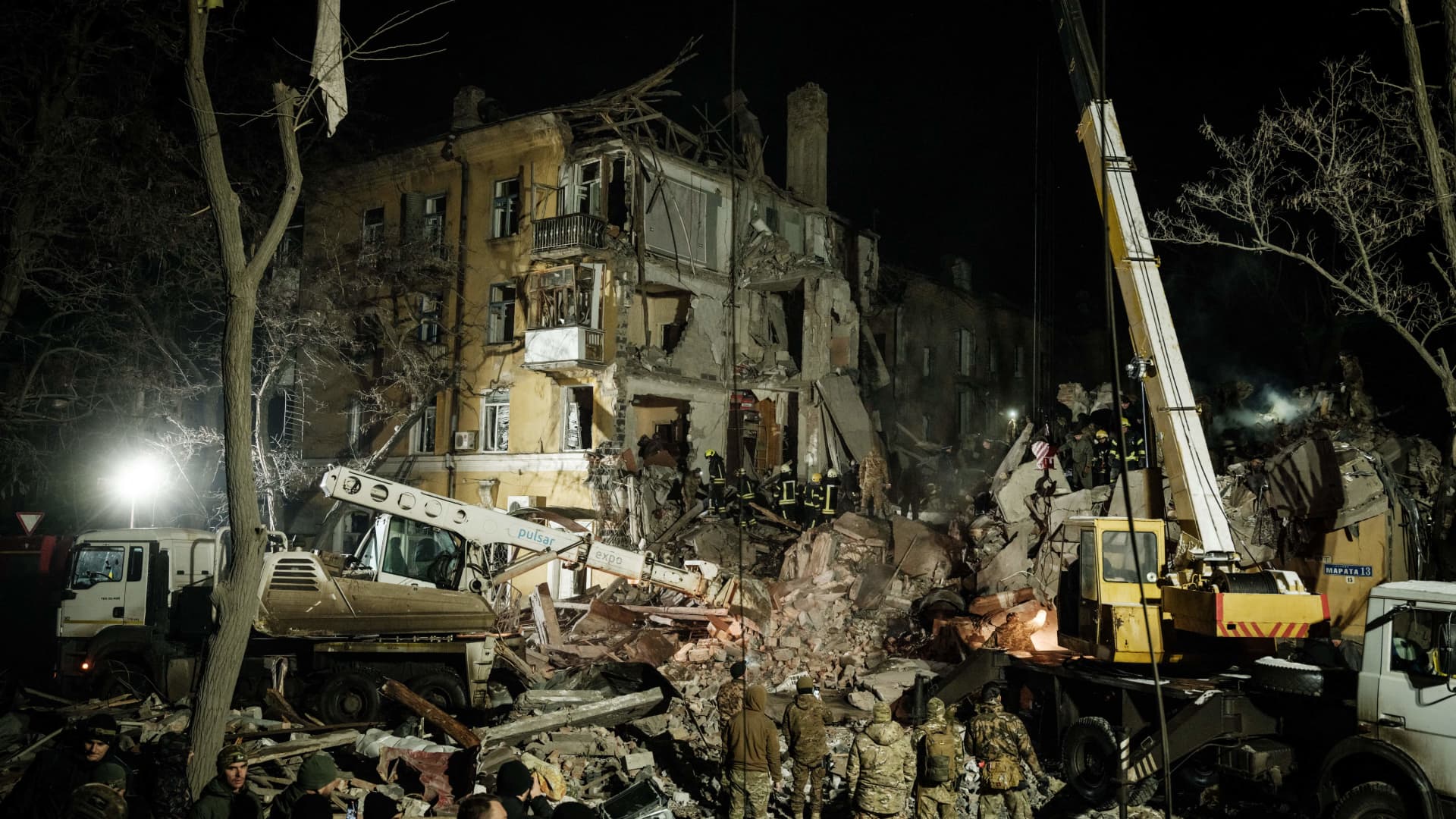 Rescuers remove debris to search for survivors at a destroyed apartment building hit by a rocket in downtown Kramatorsk on Feb. 1, 2023.