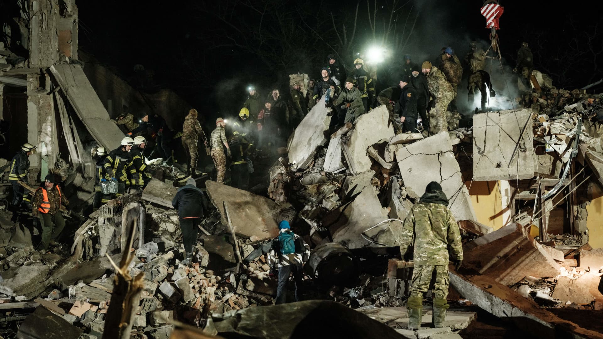 Rescuers remove debris to search for survivors at a destroyed apartment building hit by a rocket during the night in Kramatorsk on February 1, 2023.