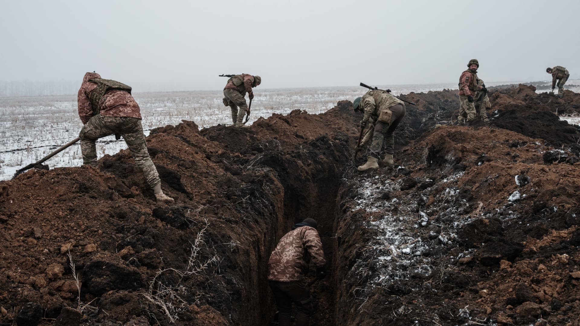 Ukrainian servicemen make a trench near Bakhmut on Feb. 1, 2023, as they prepare for a Russian offensive in the area.