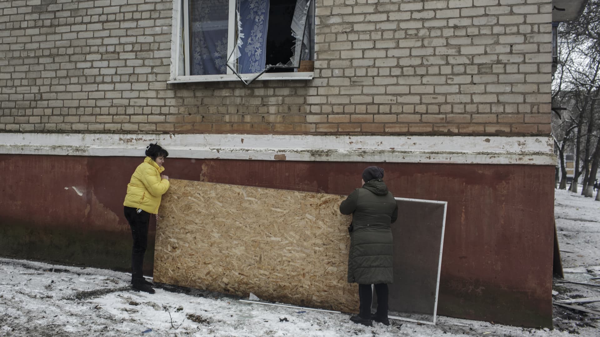 Citizens use piece of wood to repair damaged window after a Russian missile strike in Kramatorsk, Donetsk Oblast, Ukraine on February 02, 2023.