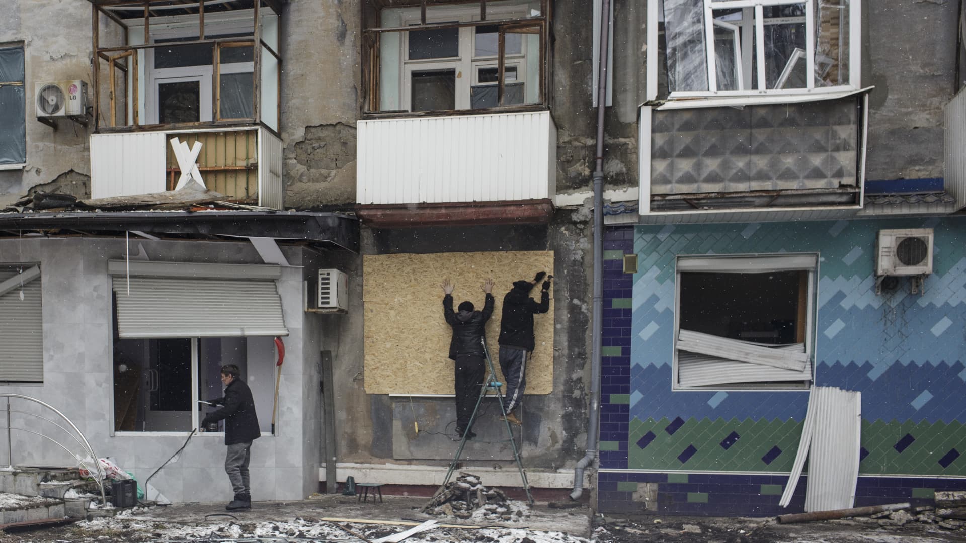 Citizens carry piece of wood which will use to repair their house damaged in the attack after a Russian missile strike in Kramatorsk, Donetsk Oblast, Ukraine on February 02, 2023. 