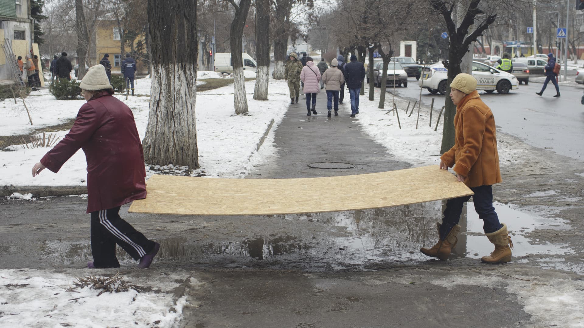 Citizens carry piece of wood which will use to repair their house damaged in the attack after a Russian missile strike in Kramatorsk, Donetsk Oblast, Ukraine on February 02, 2023. 