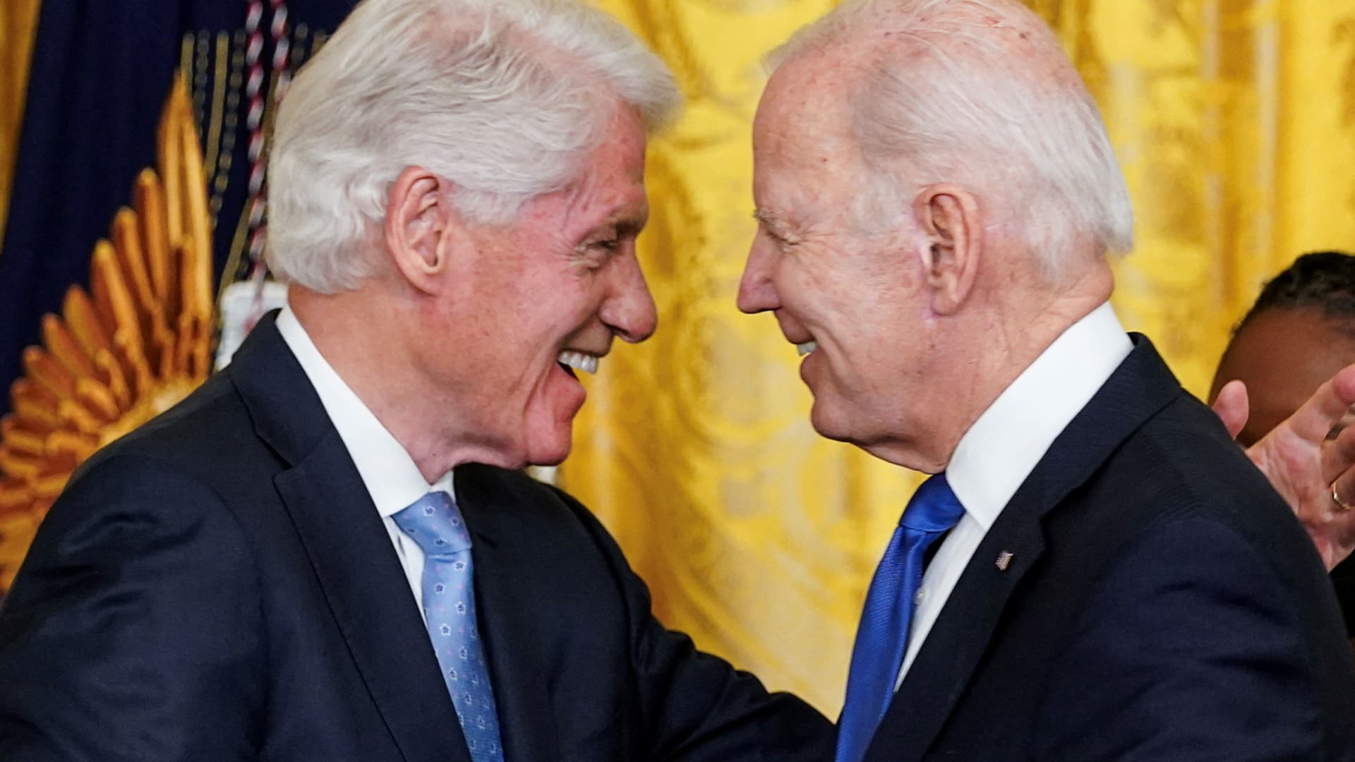 Former U.S. President Bill Clinton greets U.S. President Joe Biden during an event to mark the 30th anniversary (Feb. 5, 1993) of the Family and Medical Leave Act, in the East Room at the White House in Washington, February 2, 2023.