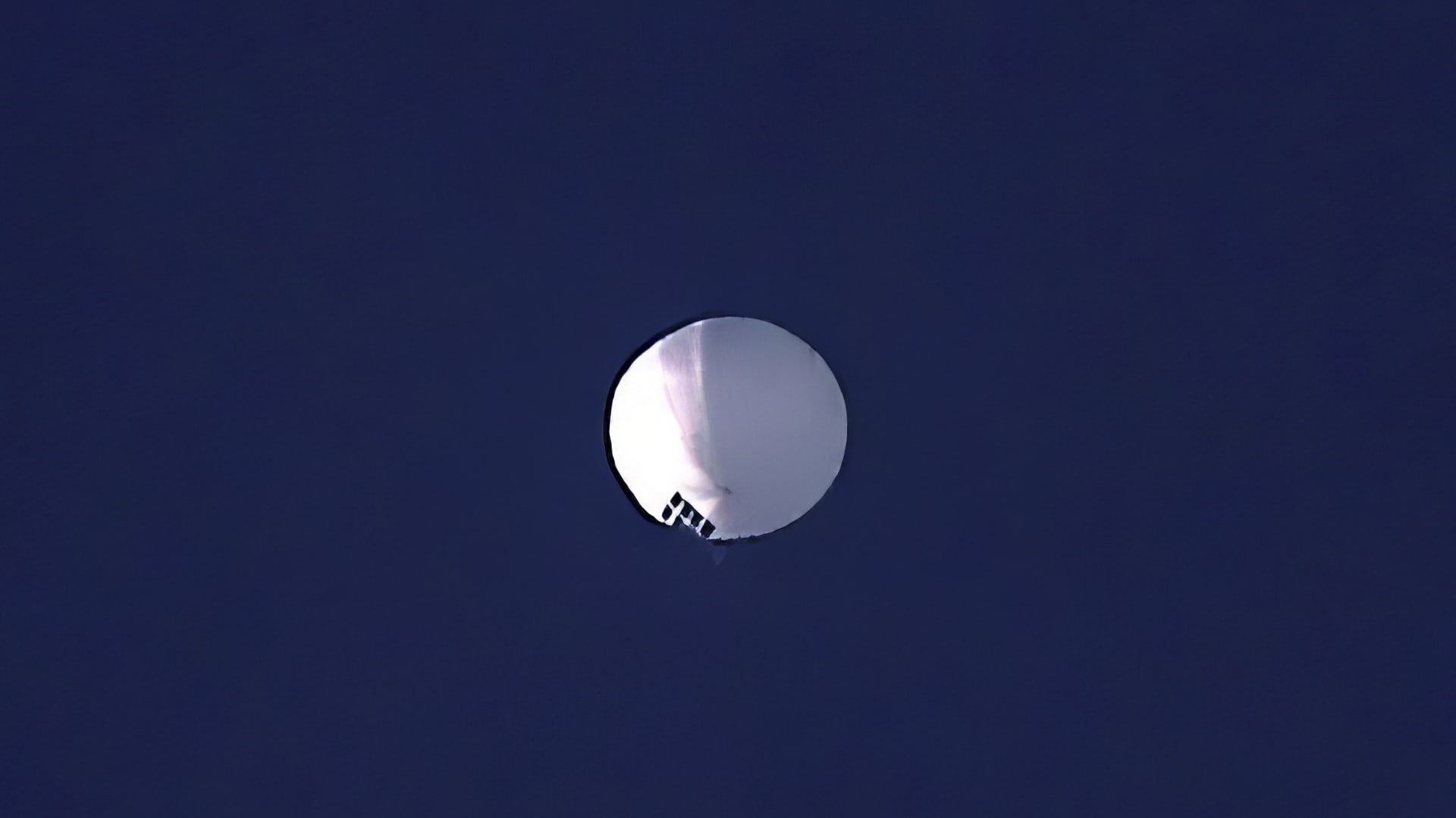 A high altitude balloon floats over Billings, Mont., on Wednesday, Feb. 1, 2023. The U.S. is tracking a suspected Chinese surveillance balloon that has been spotted over U.S. airspace for a couple days, but the Pentagon decided not to shoot it down due to risks of harm for people on the ground, officials said Thursday, Feb. 2, 2023. The Pentagon would not confirm that the balloon in the photo was the surveillance balloon.