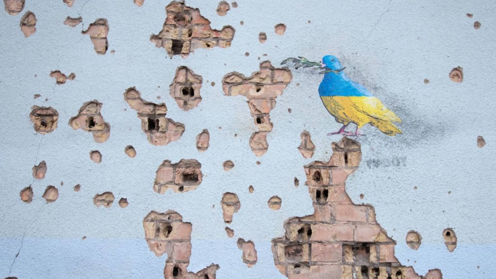 An artwork of the famous street artist Tvboy is seen on a wall of the House of Culture, which was heavily damaged during Russia's attack on Ukraine, in the town of Irpin near Kyiv, Ukraine, February 2, 2023. 