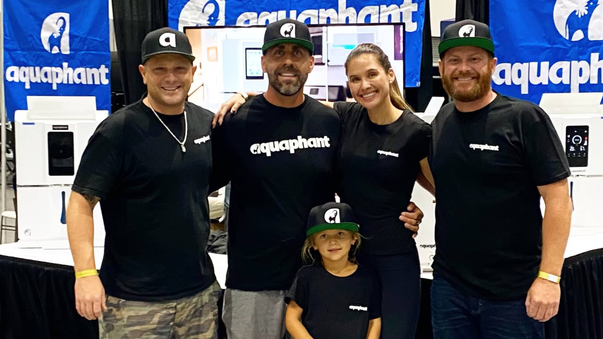 Cody Mullenaux, the inventor and founder of Aquaphant, a technology company that converts moisture from the air into filtered water, with his team and family.