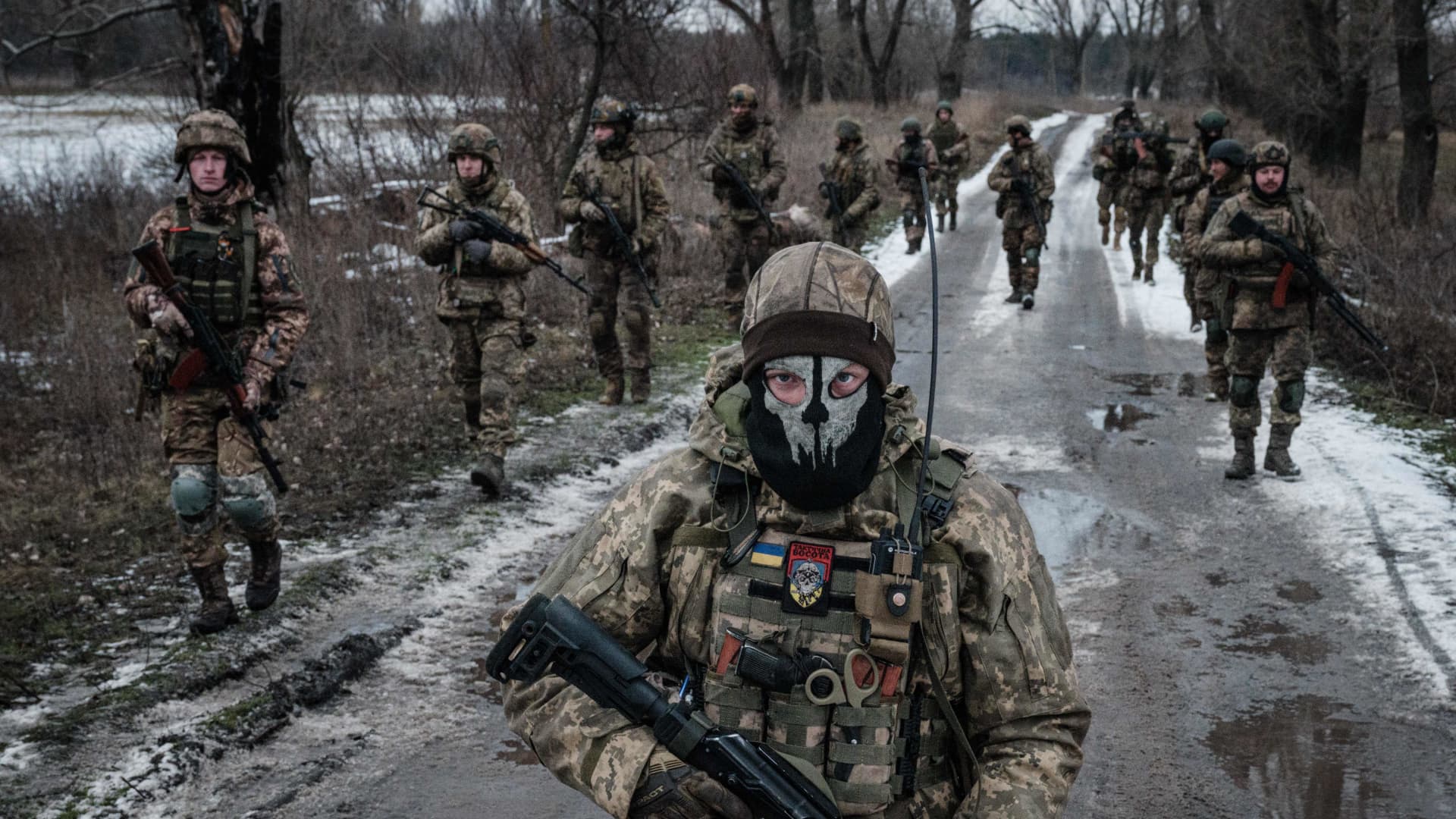 Ukrainian servicemen walk on the road toward their base near the front line in the Donetsk region on Feb. 4, 2023.