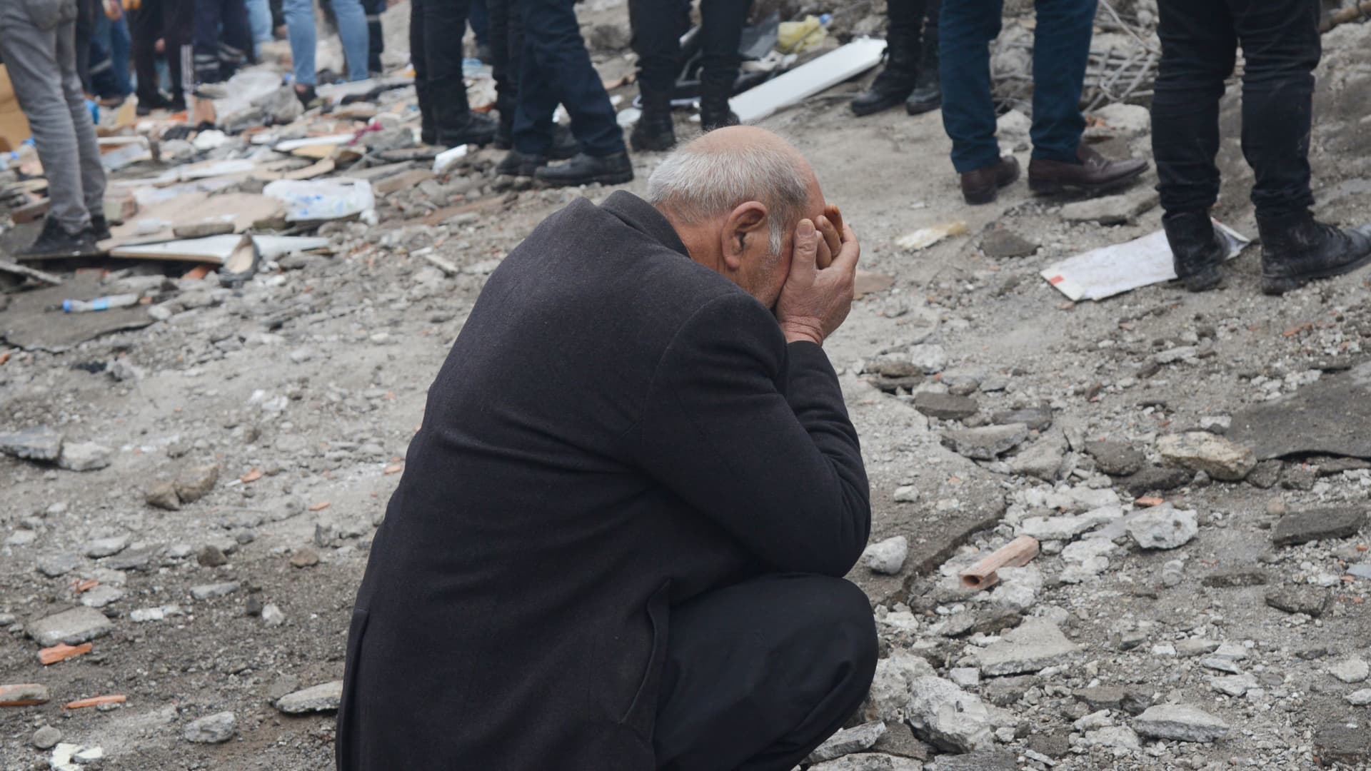 A man reacts as people search for survivors through the rubble in Diyarbakir, on February 6, 2023, after a 7.8-magnitude earthquake struck the country's south-east.