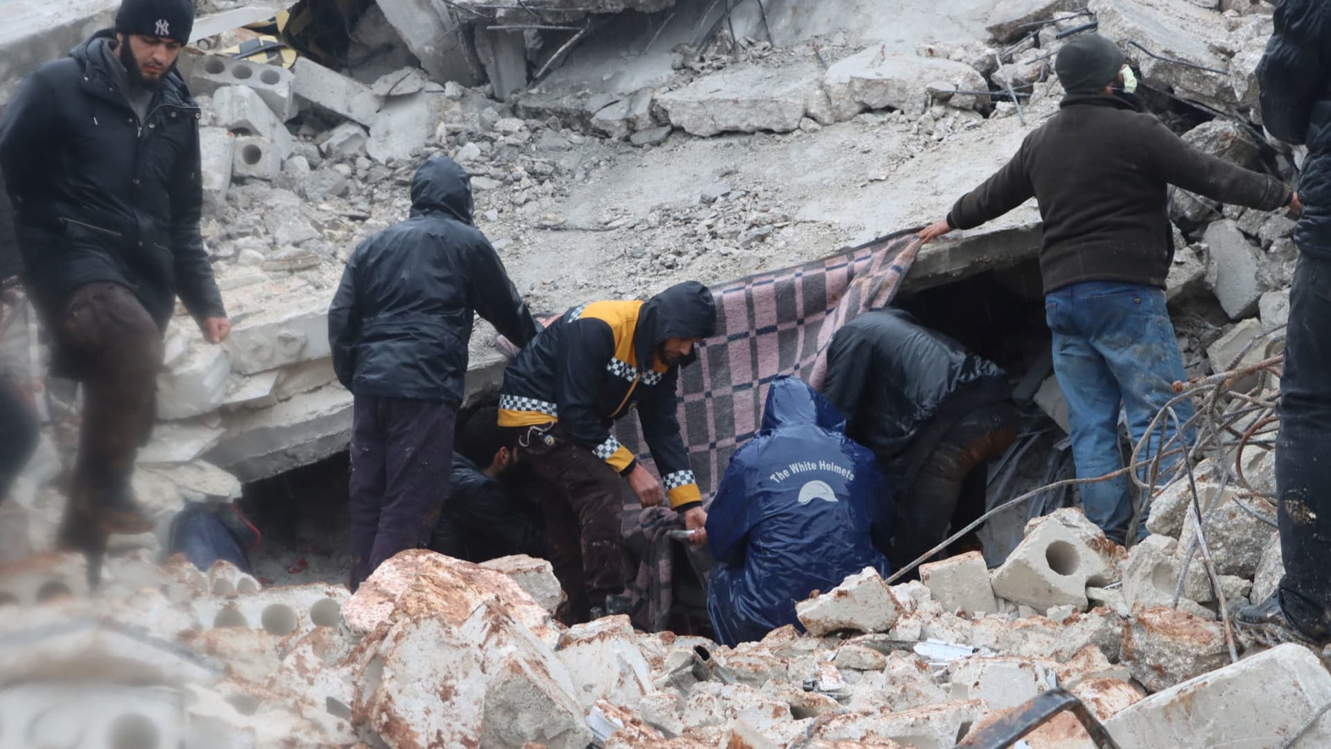 Rescuers search for survivors under the rubble, following an earthquake, in Al Atarib, Syria February 6, 2023 in this picture obtained from social media. 
