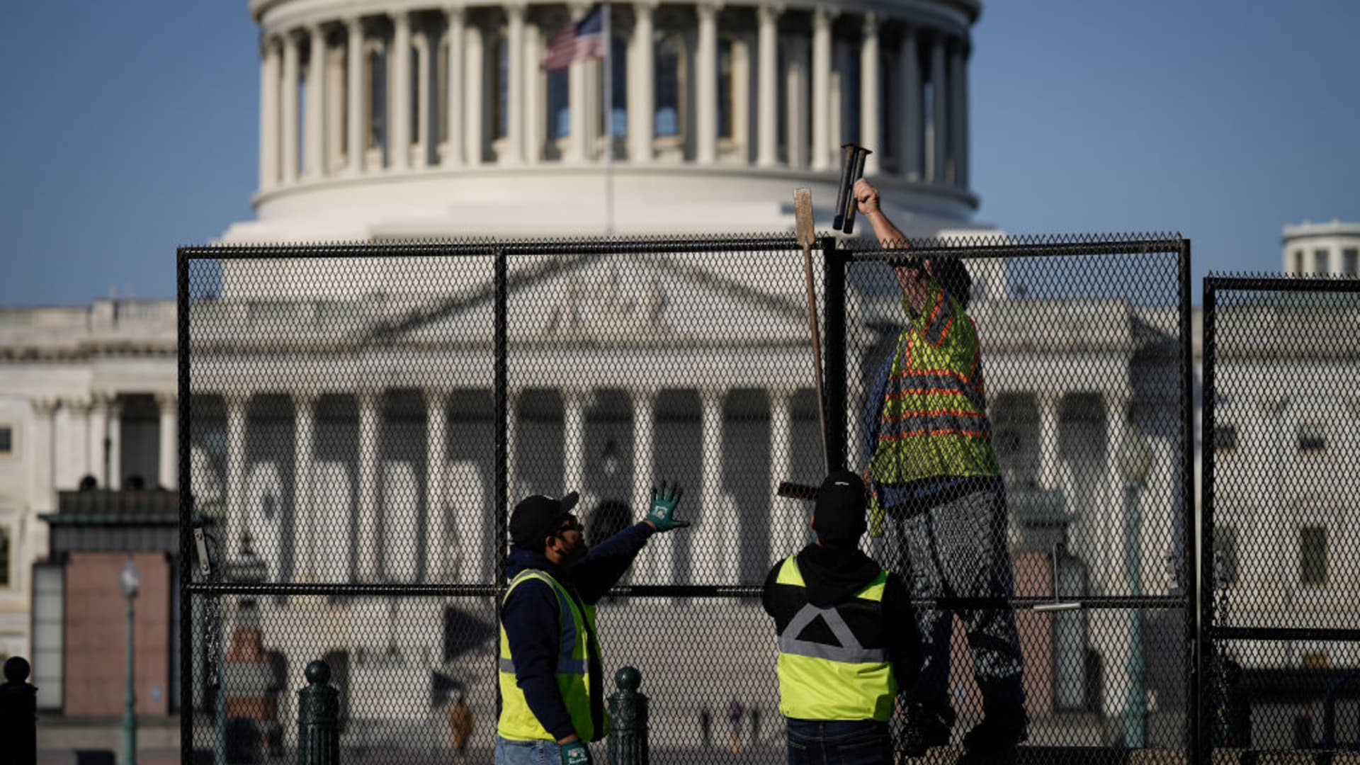 Workers install security fencing around the U.S. Capitol February 6, 2023 in Washington, DC. Security fencing has been installed as part of enhanced security measures ahead of President Joe Biden's State of the Union address on Tuesday evening.