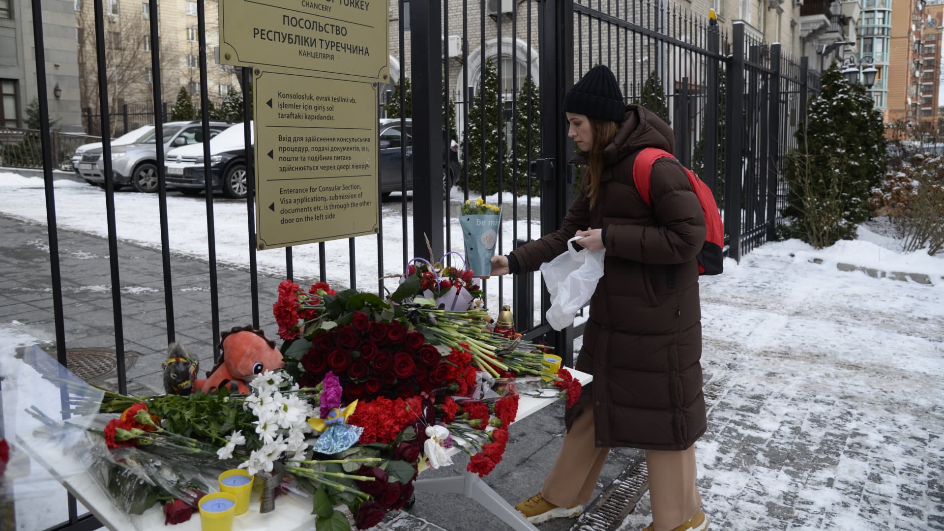 A woman leaves flowers in front of the Turkish Embassy building in Kyiv, Ukraine after 7.7 and 7.6 magnitude earthquakes hit Turkiye's Kahramanmaras, on February 07, 2023. 