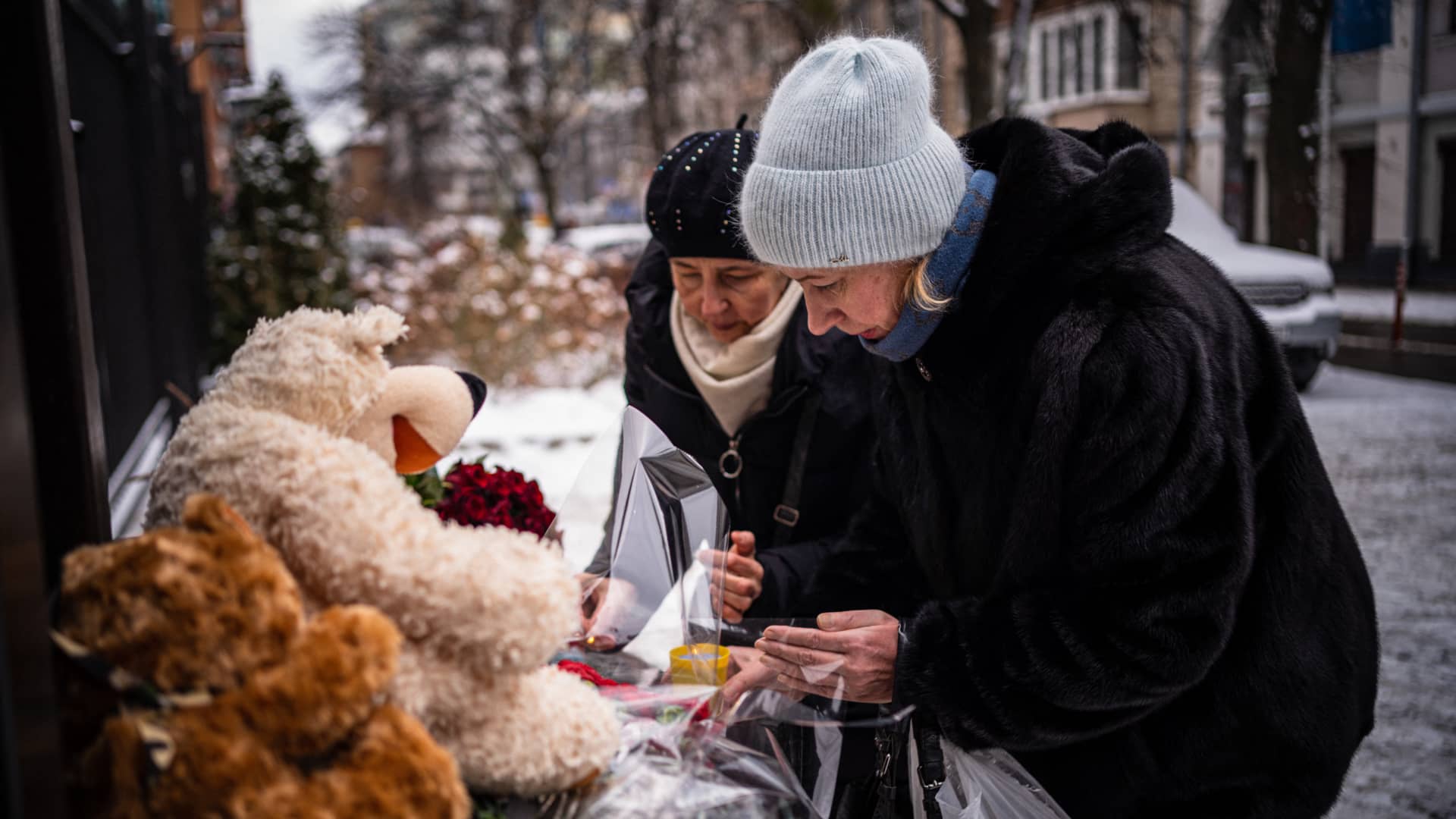 Women light candles outside the Turkish Embassy in Kyiv on February 7, 2023, to pay tribute to the victims of a massive 7.8-magnitude earthquake that struck Turkey and Syria, killing at least 4,800 people and flattening thousands of buildings.