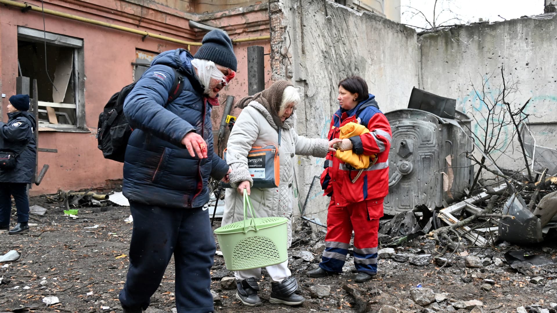 Women leave their partially destroyed residence after a Russian missile strike in Kharkiv, on Feb. 5, 2023.