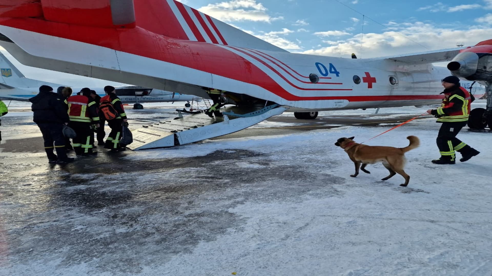 Rescuers of the State Emergency of Ukraine board a plane, on their way to help find survivors of the deadly earthquake in Turkey, at an unknown location in Ukraine February 7, 2023.