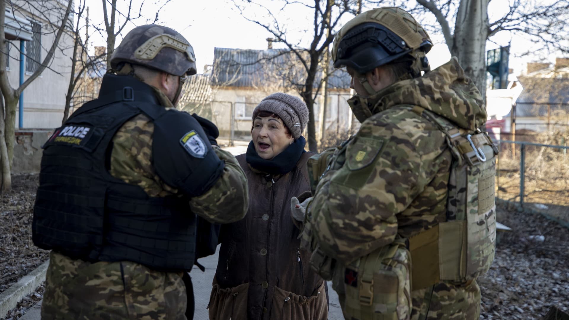 Ukrainian security forces talk to an elder woman while the first anniversary of Russia-Ukraine war approaches in Bakhmut, Ukraine on January 25, 2023. The majority of the population has been evacuated as civilians struggle to carry on with their daily lives in Bakhmut, one of the most intense frontlines of war.