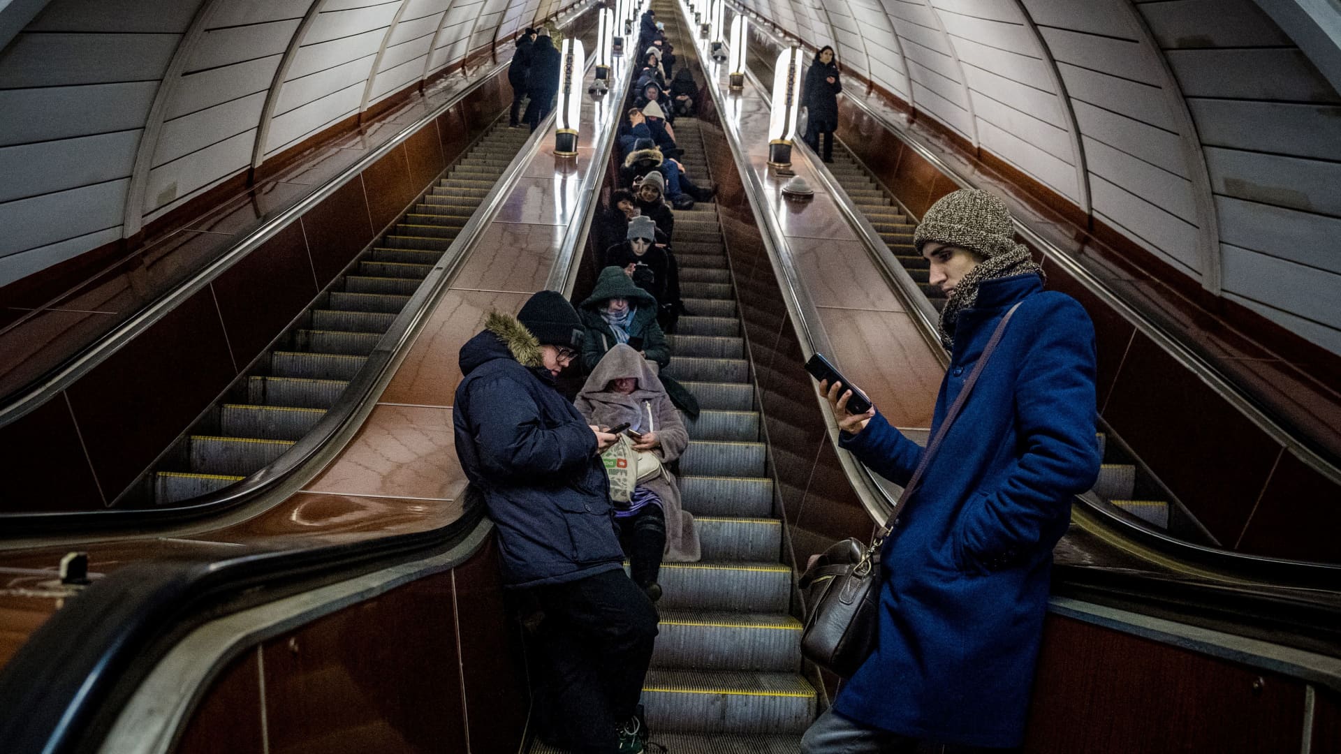Residents take shelter in a metro station during an air strike alarm in the Ukrainian capital of Kyiv on February 10, 2023, amid the Russian invasion of Ukraine. 