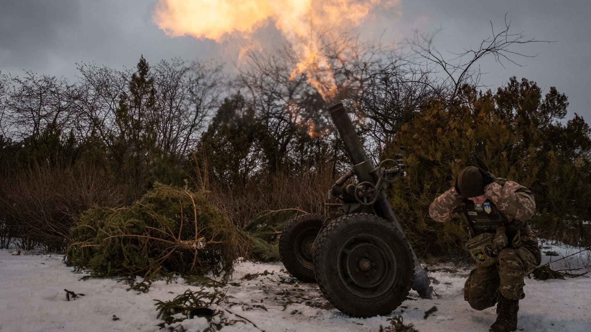 A Ukrainian serviceman of the 93rd brigade covers his ears while firing a French 120mm rifled towed mortar (designated as a MO-120-RT-61) towards Russian positions in Bakhmut on February 15, 2023, amid the Russian invasion of Ukraine. 