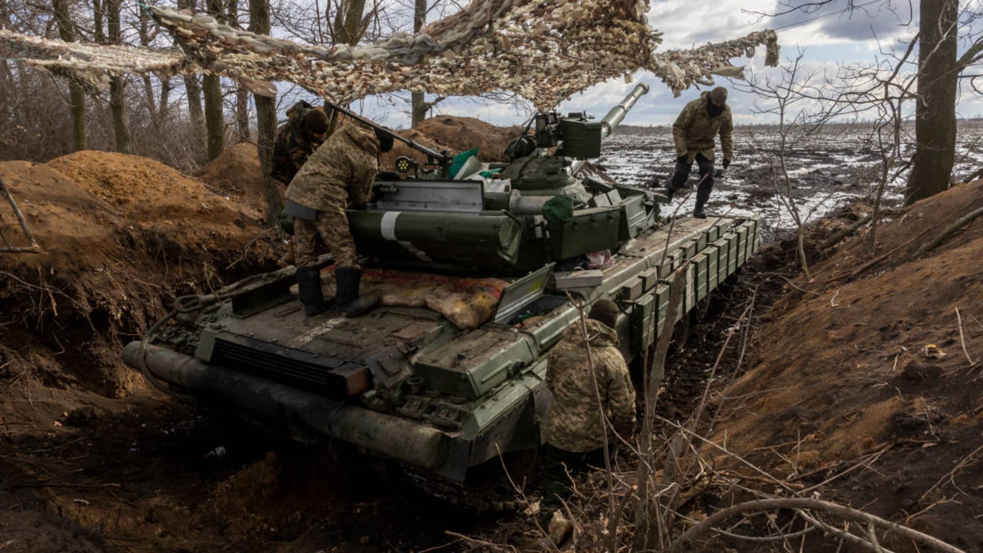 Ukrainian Marines prepare their T-64 tank for action while dug in to a treeline on February 15, 2023 in the Donbass region of eastern Ukraine. 