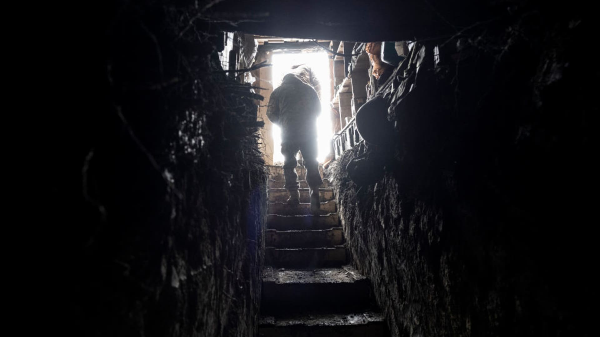 Ukrainian Marines emerge from an underground bunker at their unit's tank position on February 15, 2023 in the Donbass region of eastern Ukraine. 