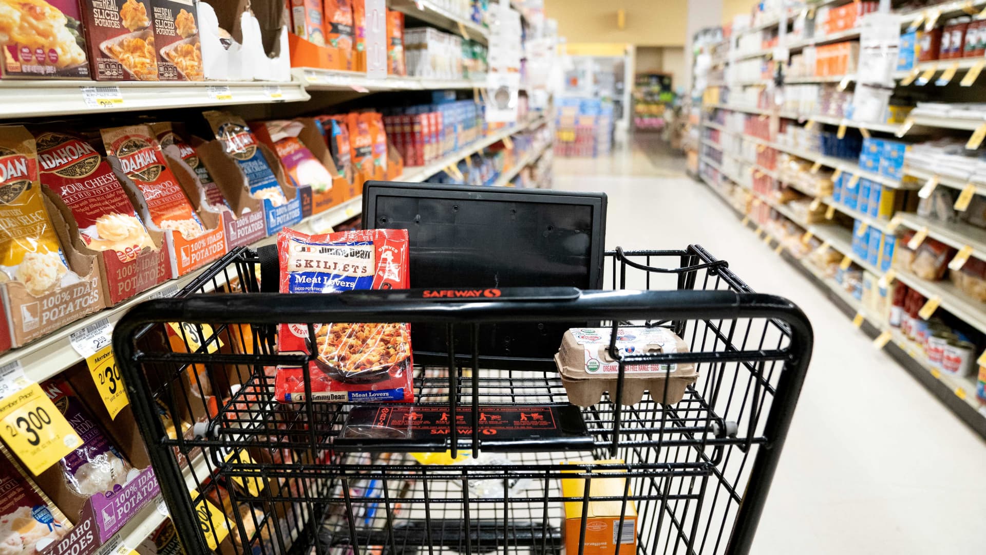 A grocery cart sits in an aisle at a grocery store in Washington, DC, on February 15, 2023.