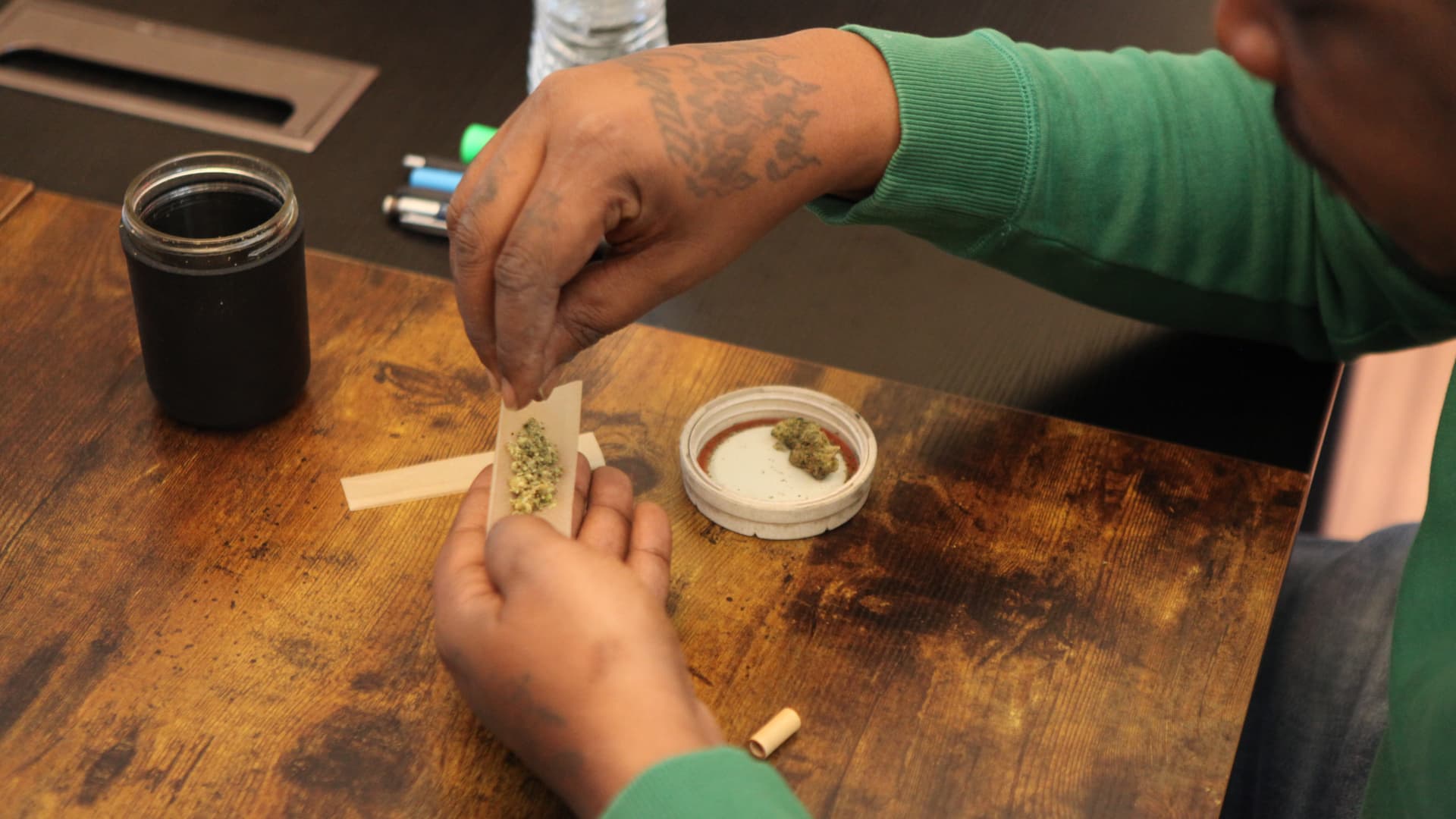 John Dockery rolls a joint. He's sold marijuana since he was a teenager in the 1990s. 