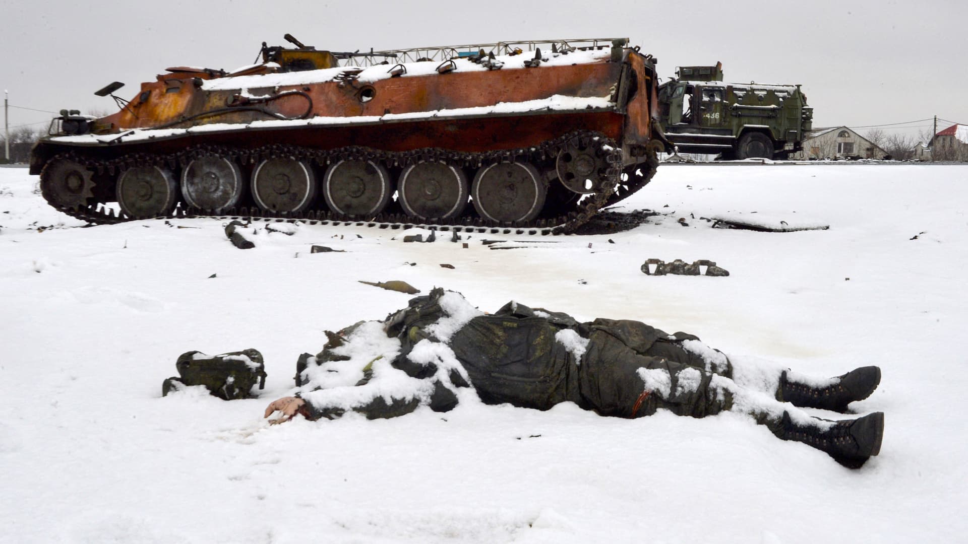 The body of a Russian serviceman lies near destroyed Russian military vehicles on the roadside on the outskirts of Kharkiv on Feb. 26, 2022, following the Russian invasion of Ukraine.