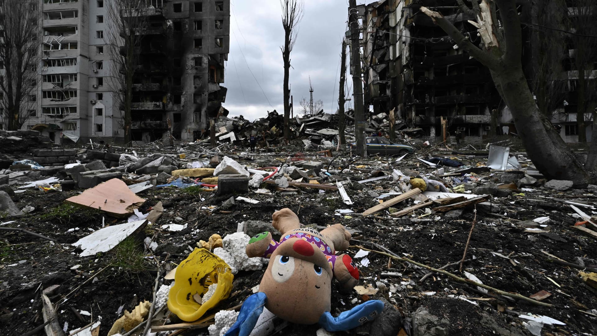 This photograph taken on April 6, 2022, shows a toy and personal belongings among rubble in front of a destroyed residential building in the town of Borodyanka, northwest of Kyiv.