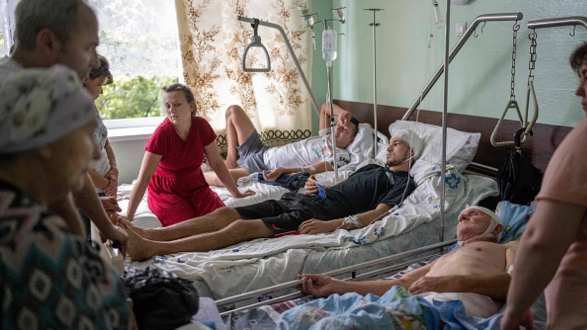 Relatives gather in a hospital around three men injured in a missile strike in Mykolaiv, on Aug. 18, 2022, amid the Russian invasion of Ukraine.