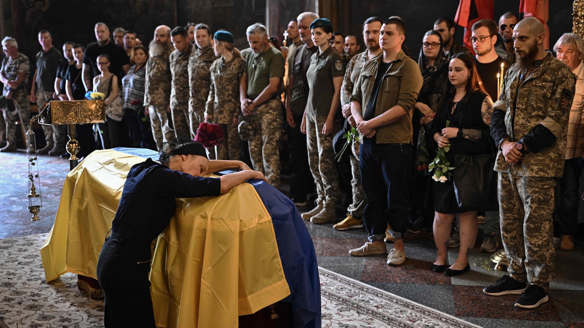 Nadiya, the mother of late Ukrainian serviceman Roman Barvinok, mourns at his coffin during a funeral service in St. Michael's Golden-Domed Cathedral in Kyiv on Aug. 28, 2022, amid the Russian invasion of Ukraine.