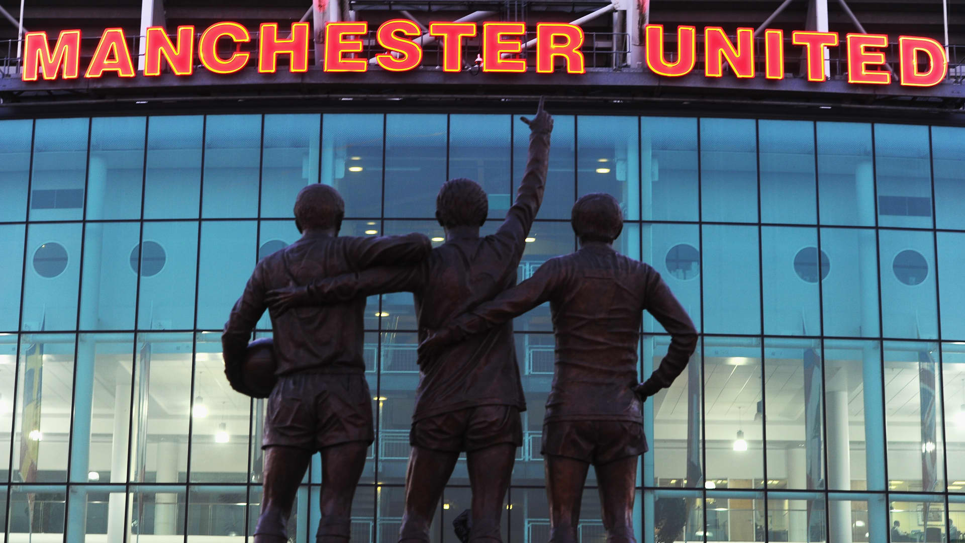 A statue of George Best, Denis Law and Bobby Charlton standing outside Old Trafford, home of Manchester United in Manchester, England.
