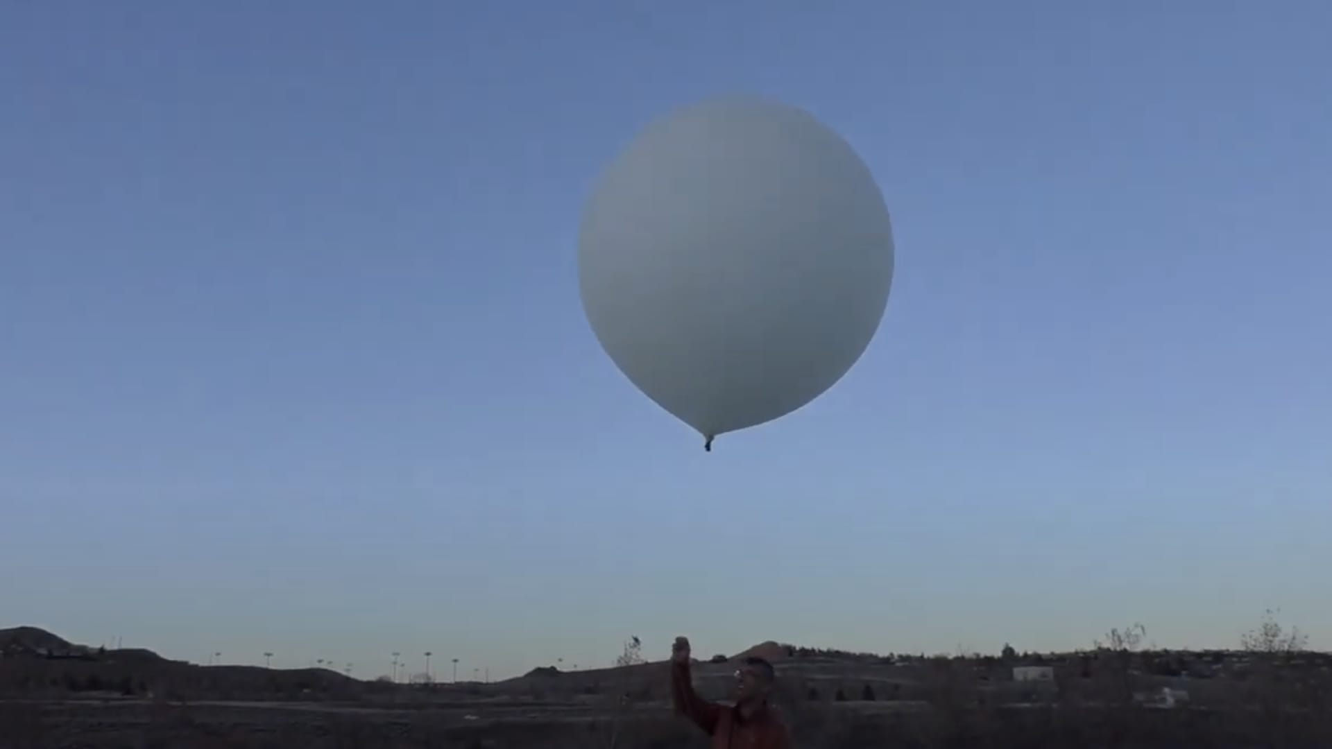 Luke Iseman, the founder of Make Sunsets, is about to launch a weather balloon filled with sulfur dioxide and helium into the air in Nevada.
