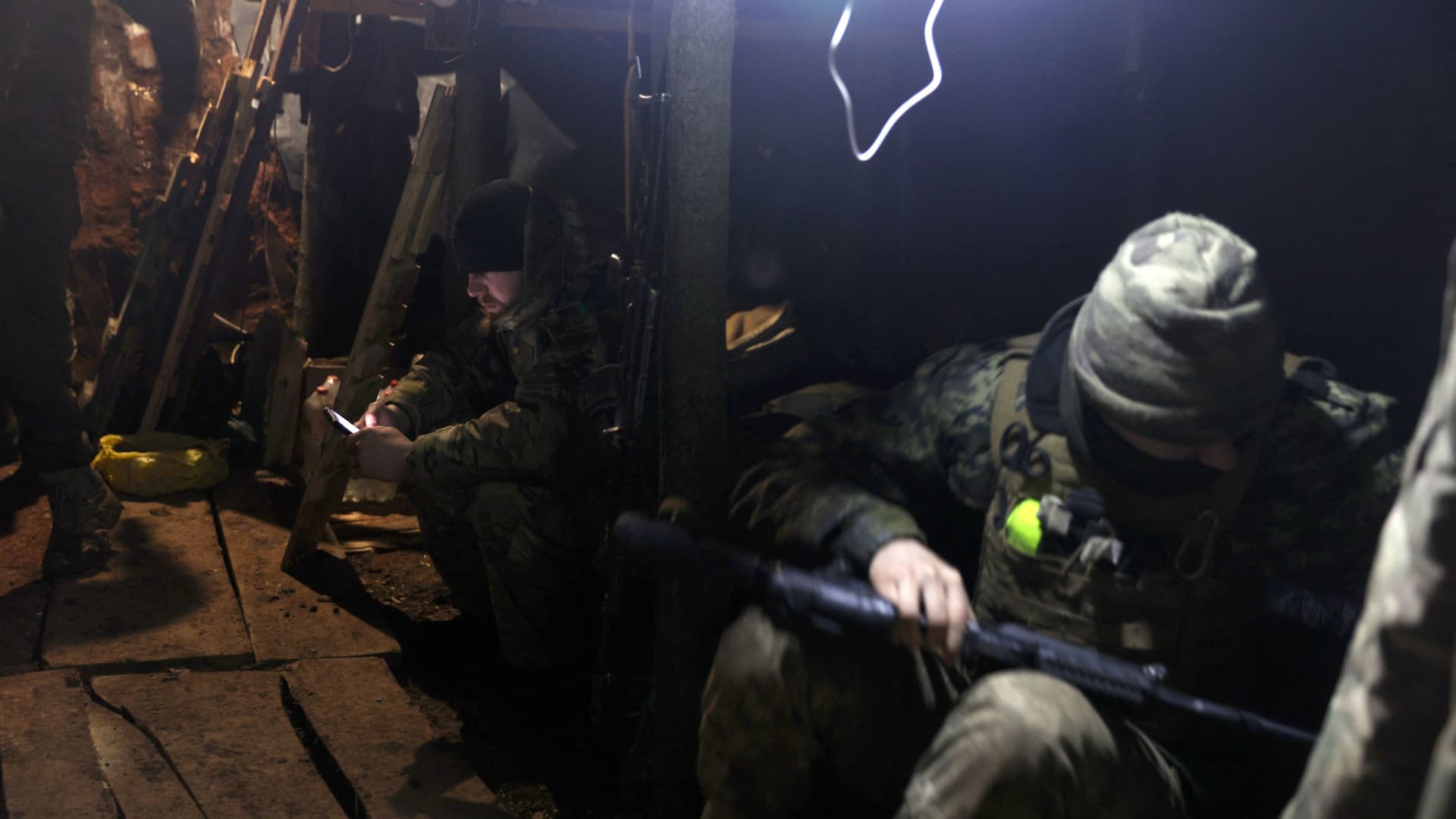 Ukrainian soldiers rest in a dugout on the front line near Bakhmut in the Donetsk region on Feb. 21, 2023.