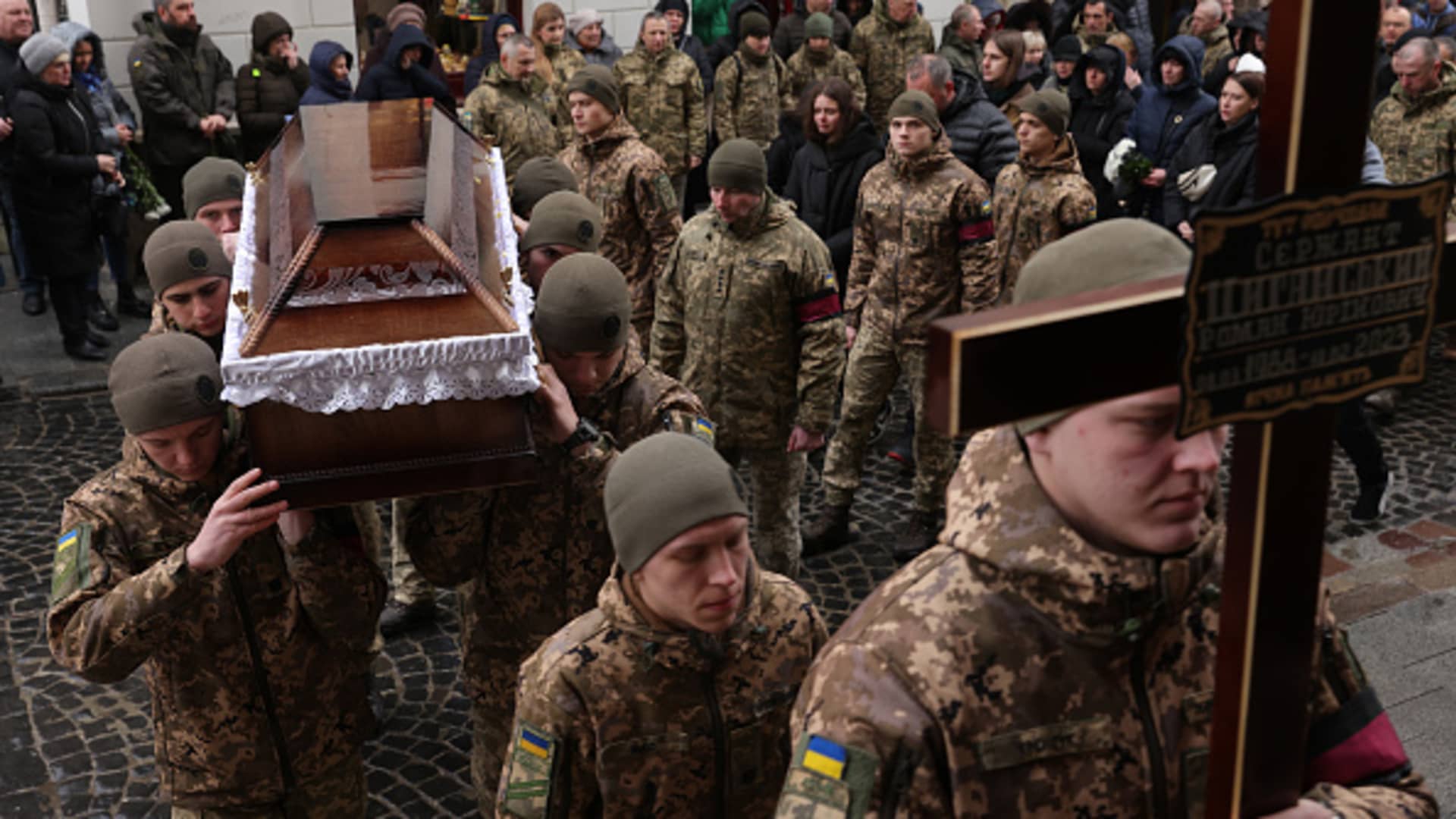 Soldiers carry the coffins of fellow soldiers Roman Tsyganskyi, 34, at his funeral and that of Yuriy Gubyak, 37, at the Church of the Most Holy Apostles Peter and Paul on February 24, 2023 in Lviv, Ukraine.