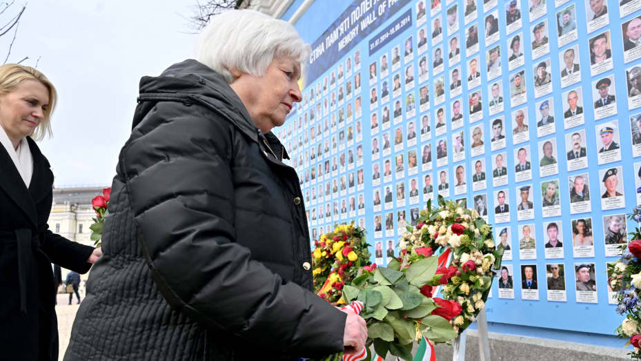 US Secretary of the Treasury Janet Yellen lays flowers to a Memory Wall of Fallen Defenders of Ukraine in the Russian-Ukrainian War during her visit to Kyiv on February 27, 2013, amid the Russian invasion of Ukraine.