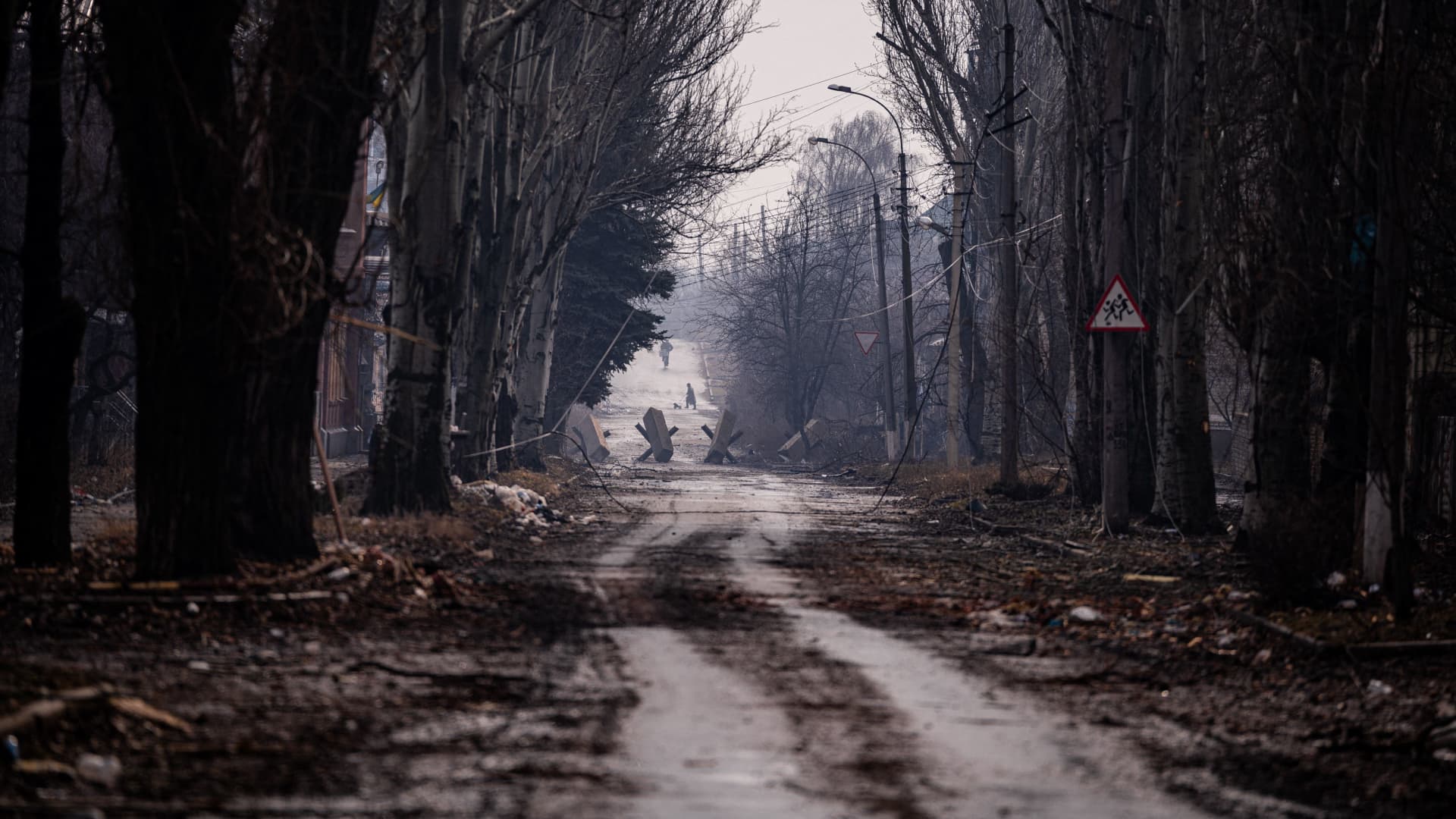 Local residents walk down a street as the sounds of shelling continue in Bakhmut on February 27, 2023.