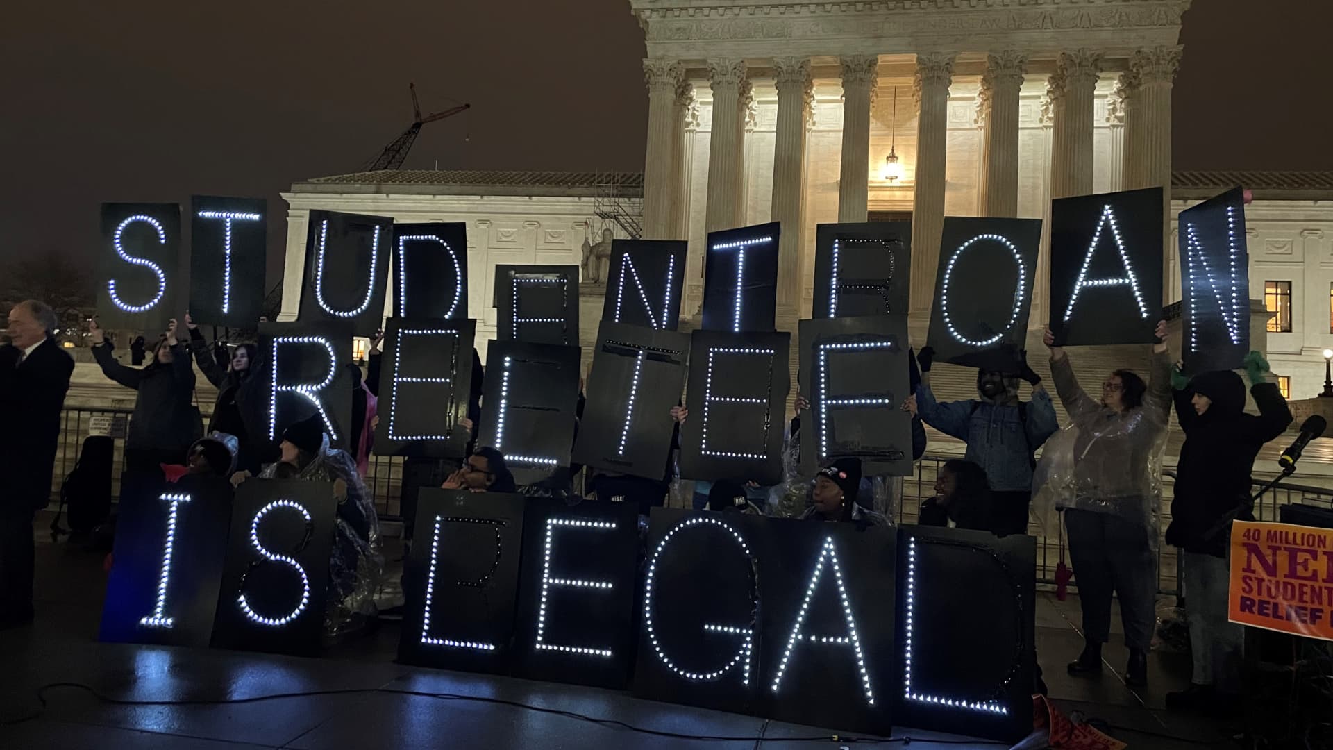 Student loan borrowers gathered outside the U.S. Supreme Court on Feb. 27, 2023, the night before the court hears two cases on student loan forgiveness.