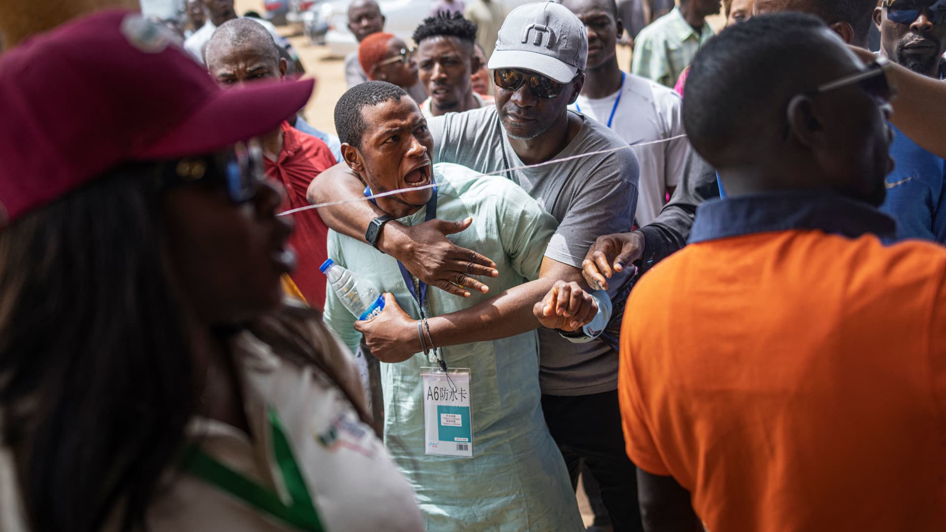 ABUJA, Nigeria - Feb. 25, 2023: A party observer argues with an official of the Independent National Electoral Commission (INEC) as ballot boxes are reportedly set up in the wrong polling station in Abuja.