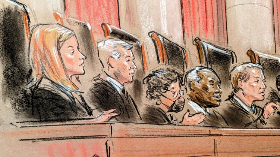 Supreme Court justices listen to arguments.